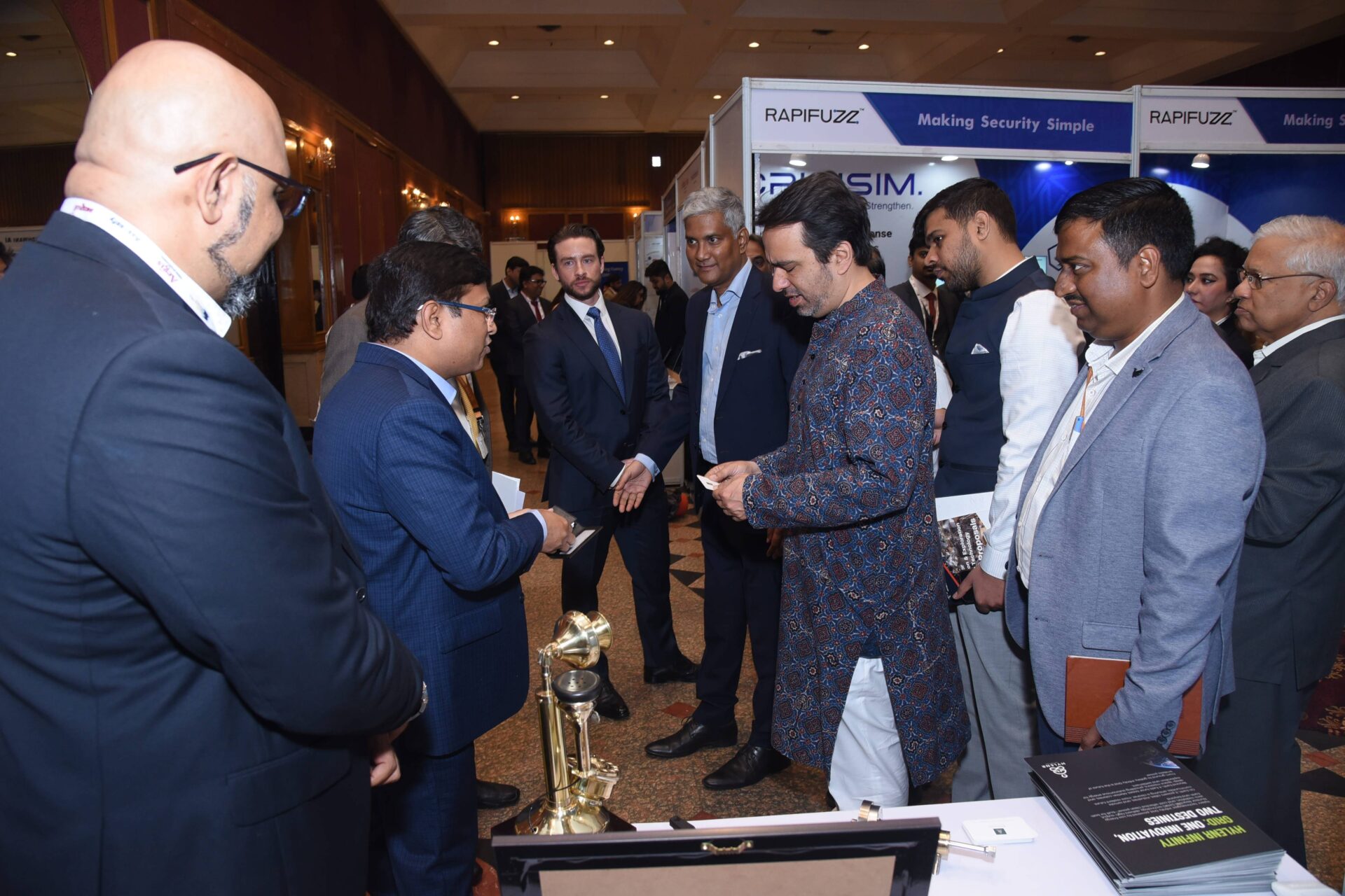 DSC_0876 Delegates networking in the exhibition area beside the Aegis Graham Bell Awards trophy